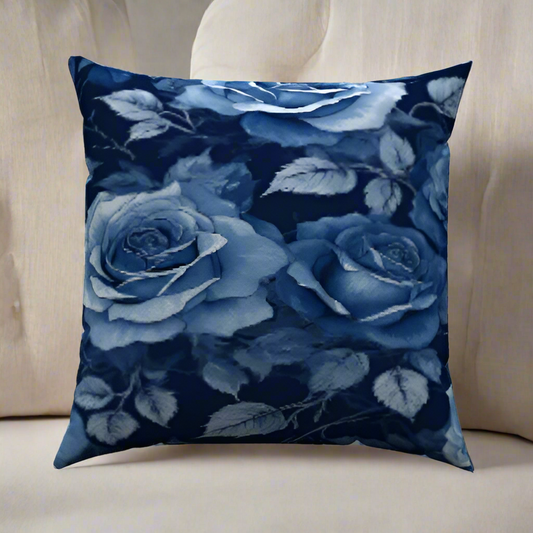 Rosalie Cotton Throw Pillow with navy and white floral design on a white sectional for cozy living room style.